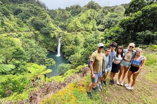 A group above a waterfall on the Road to Hana